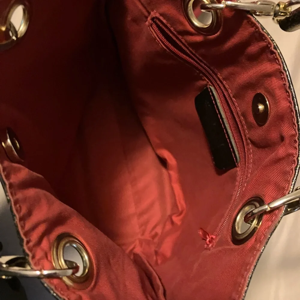 Cute , fun , gold shimmer trimmed n gold and red handbag made in Italy.